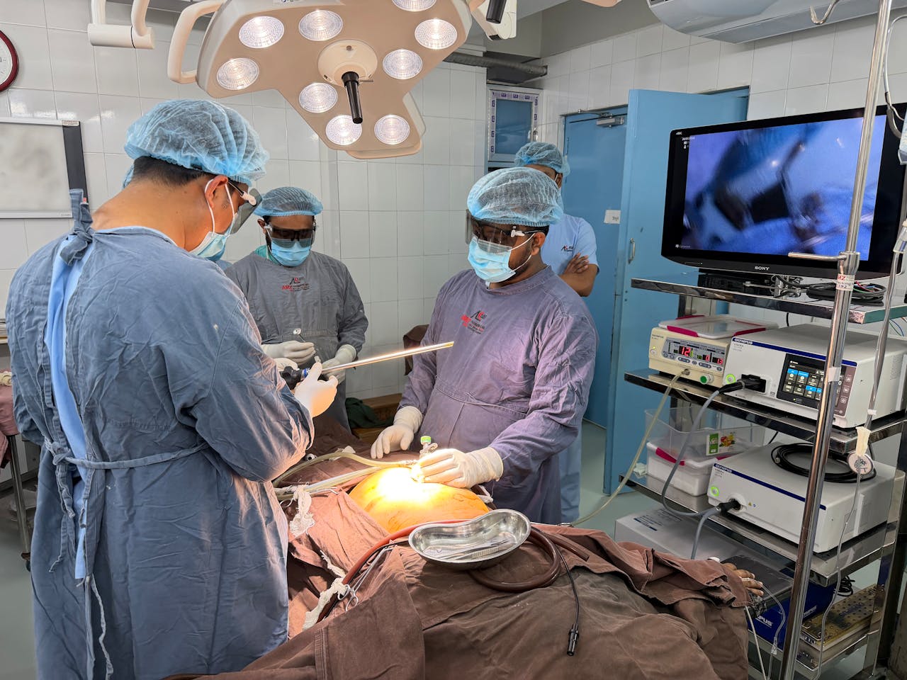 Medical team performs surgery in an operating room in Dhaka, Bangladesh. Teamwork and precision.